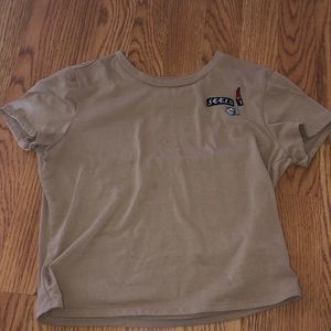 tan crop top with lipstick and dice